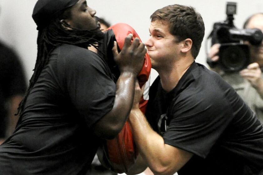 Texas A&M; offensive tackle Luke Joeckel, right, works during a blocking drill during pro day.