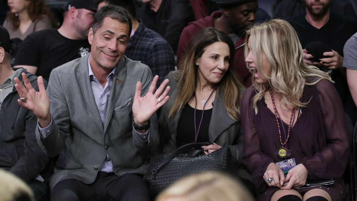 Lakers general manager Rob Pelinka, left, chats with Linda Rambis, center, and Lakers owner Jeanie Buss during a game between the Lakers and Clippers at Staples Center in March 2017.