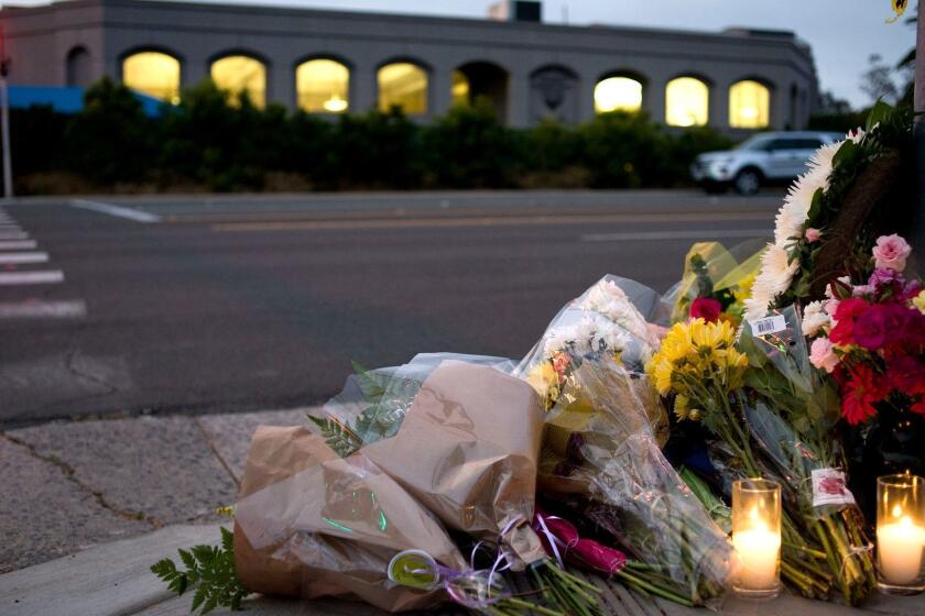 Mandatory Credit: Photo by DAVID MAUNG/EPA-EFE/REX (10221055b) Flowers and candles sit at a makeshift shrine across the road from the Chabad of Poway synagogue in Poway, California, USA, 27 April 2019 (issued 28 April 2019). An attack yesterday on the Chabad of Poway synagogue left one person dead and three injured. Poway synagogue shooting aftermath, USA - 27 Apr 2019 ** Usable by LA, CT and MoD ONLY **