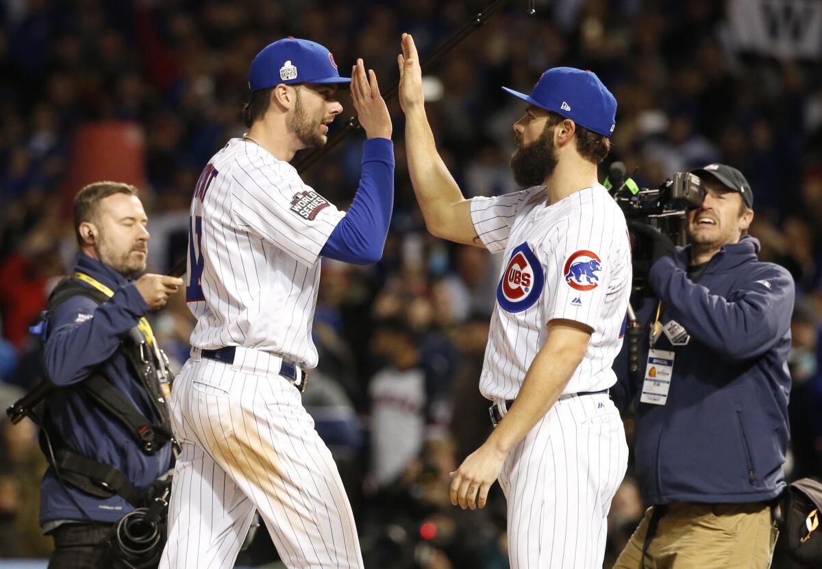 Cubs third baseman Kris Bryant, second from left, celebrates with pitcher Jake Arrieta after Game 5 of the World Series against the Cleveland Indians.