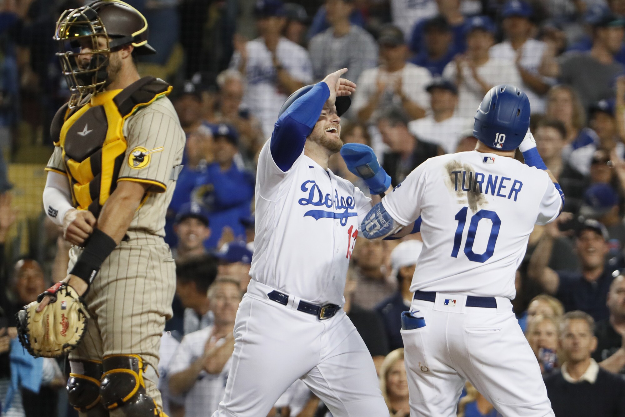 Justin Turner, right, celebrates with Dodgers teammate Max Muncy after hitting a two-run home run.