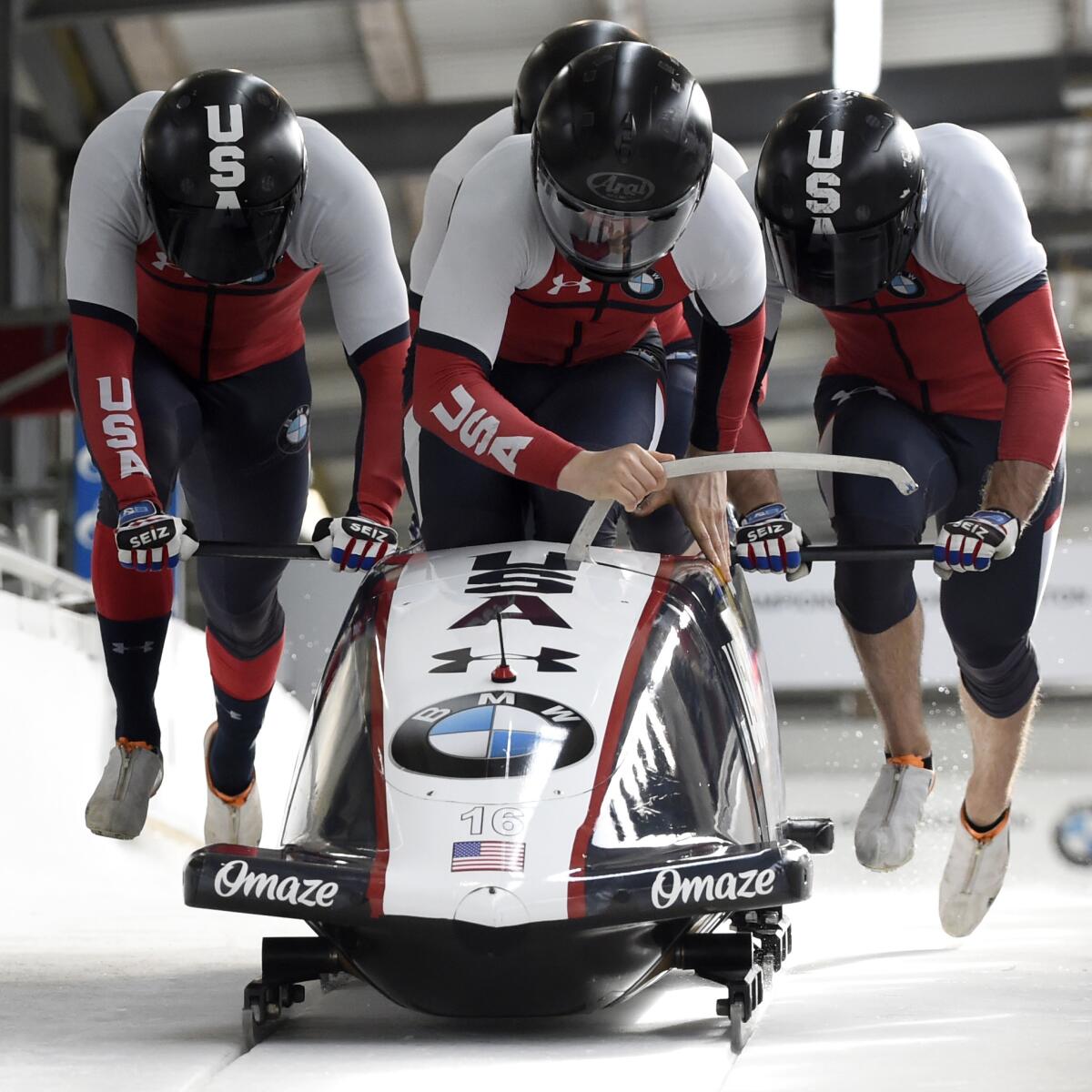 Hunter Church, Josh Williamson, James Reed and Kris Horn push the sled at the start of a heat.