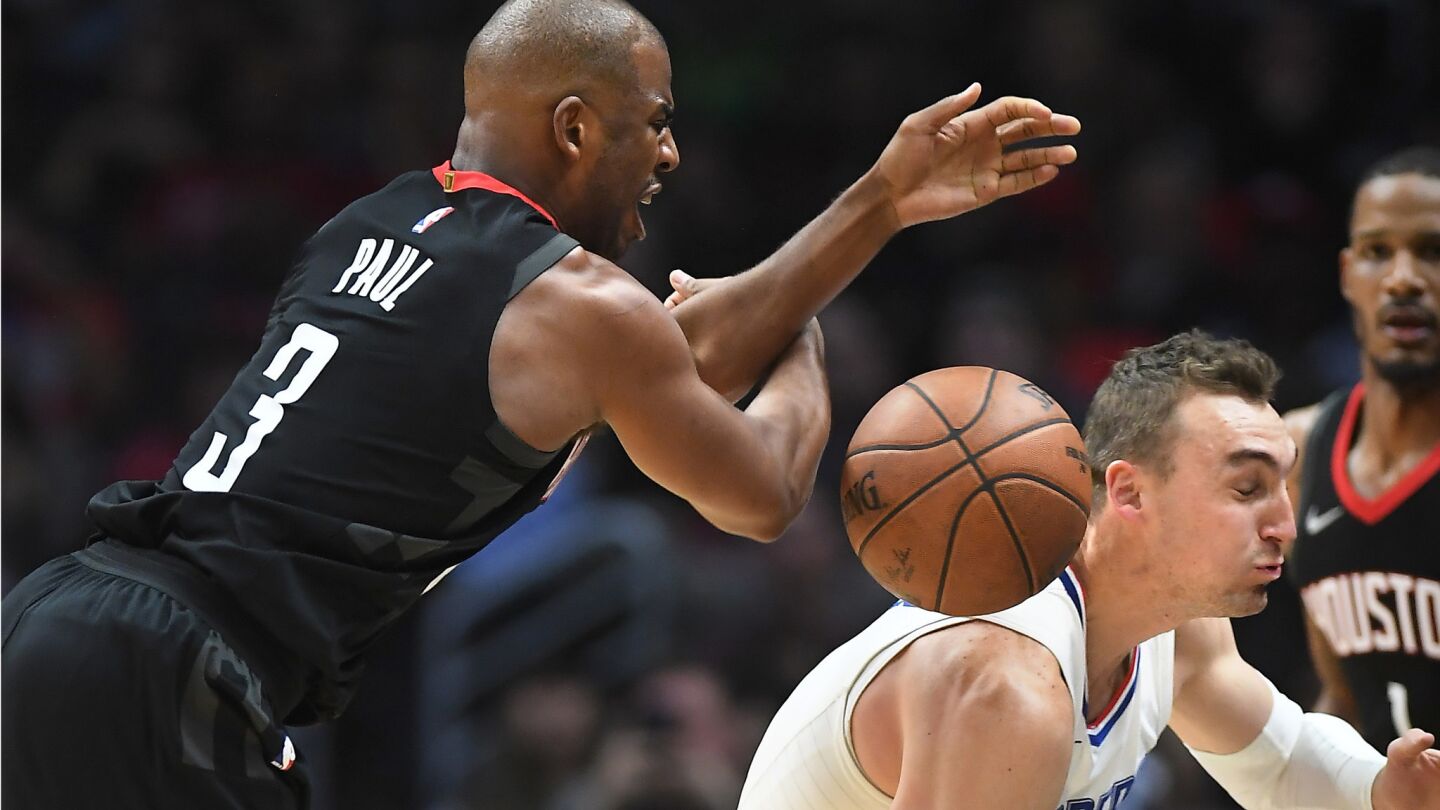 Clippers' Sam Dekker tries to steal the ball away from Houston Rockets' Chris Paul on an inbound pass in the second quarter.