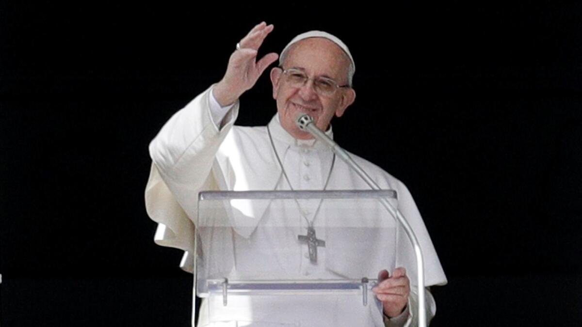 Pope Francis, shown waving to people in St. Peter's Square, has said he might be open to married men serving as priests to help relieve a shortage of priests in some regions.