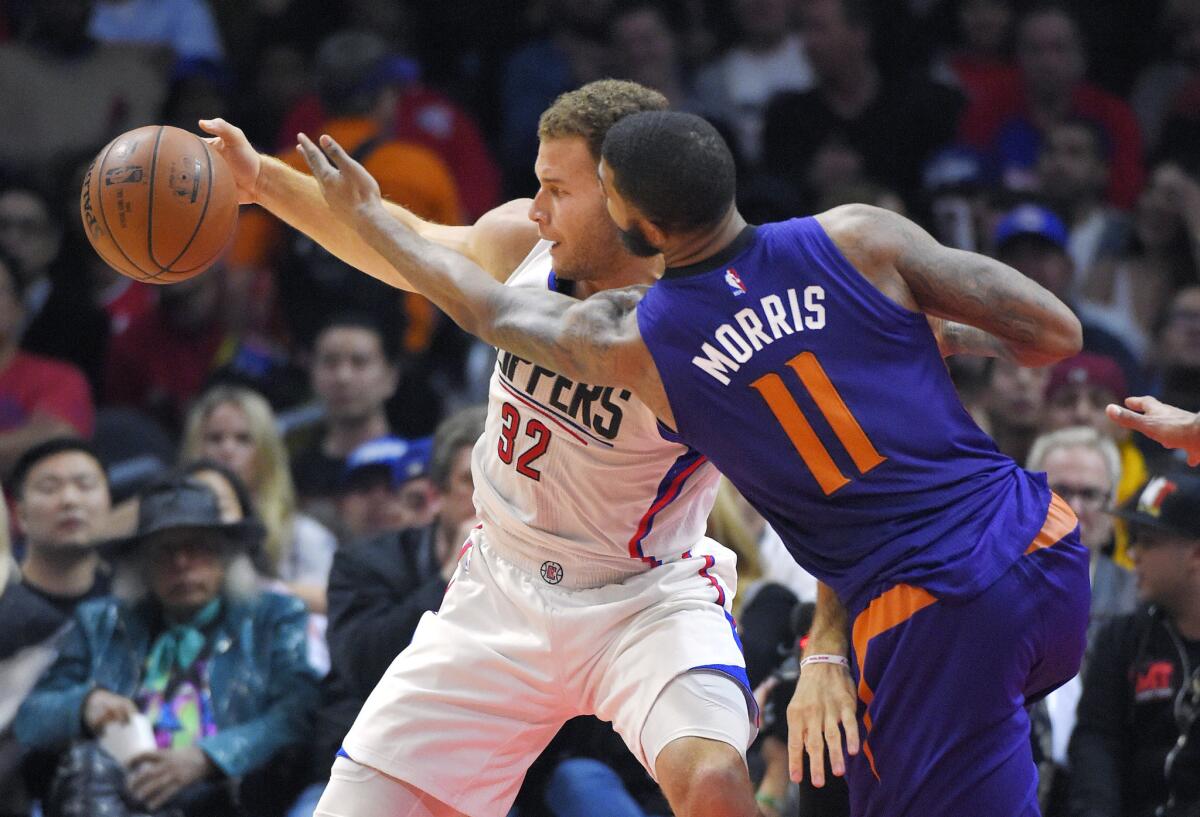 The Clippers' Blake Griffin and Phoenix's Markieff Morris go after a loose ball during a Nov. 2 game at Staples Center.
