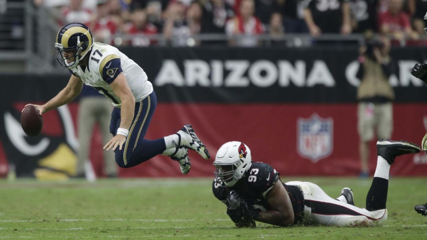 Rams quarterback Case Keenum escapes the sack of Cardinals defensive tackle Calis Campbell during second half action.