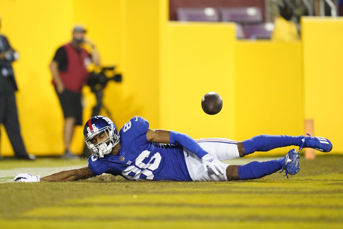 New York Giants wide receiver Darius Slayton (86) drops a pass as he goes sliding into the end zone during the second half of an NFL football game against the Washington Football Team, Thursday, Sept. 16, 2021, in Landover, Md. (AP Photo/Patrick Semansky)
