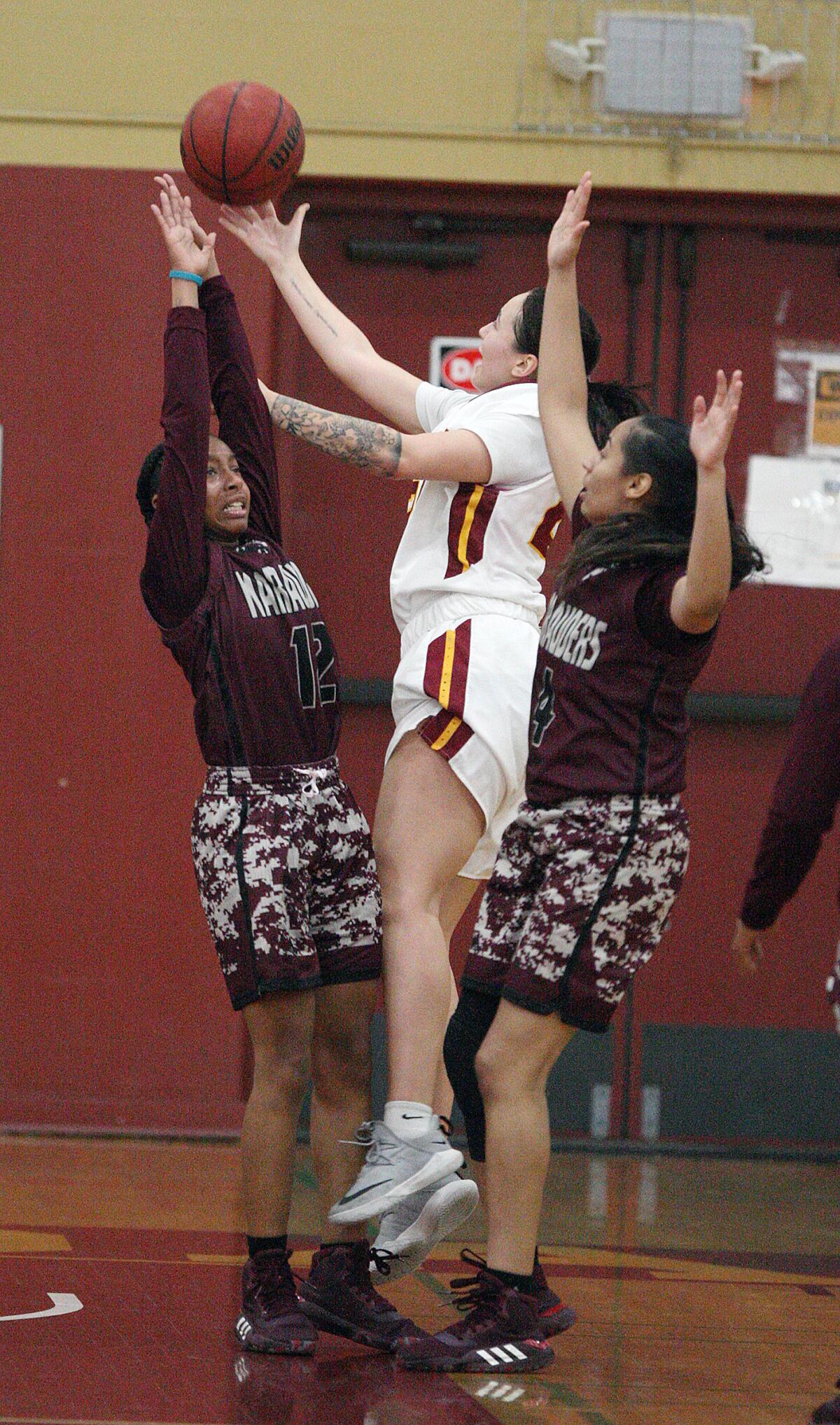 Glendale Community College's Jada Aldana jumps between Antelope Valley defenders Malaiya Patton and Sara Navarro in a Western State Conference women's basketball game at Glendale Community College on Wednesday, January 22, 2020.