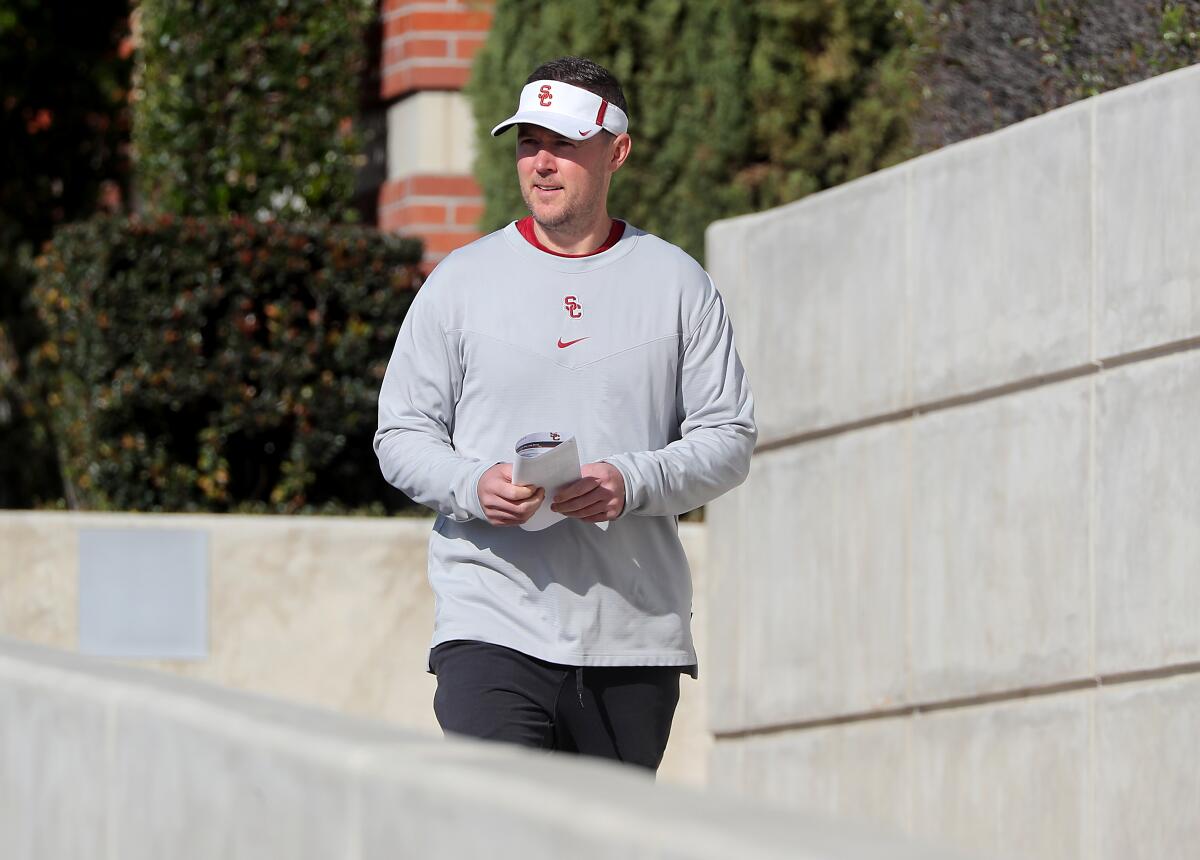 USC football coach Lincoln Riley walks toward the Trojans' practice at Howard Jones Field 