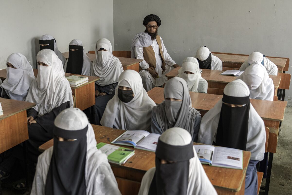 FILE- Afghan girls attend a religious school, which remained open since the last year's Taliban takeover, in Kabul, Afghanistan, Aug 11, 2022. Afghan girls will be allowed to take their high school graduation exams this week, an official and documents from the Taliban government indicated Tuesday, Dec. 6, 2022 even though they have been banned from classrooms since the former insurgents took over the country last year. (AP Photo/Ebrahim Noroozi, File)