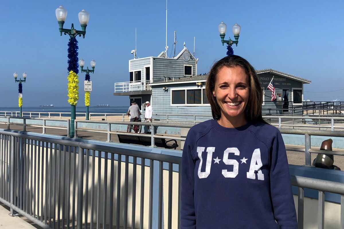 Seal Beach resident Danielle Sams stands in front of the city's pier. 