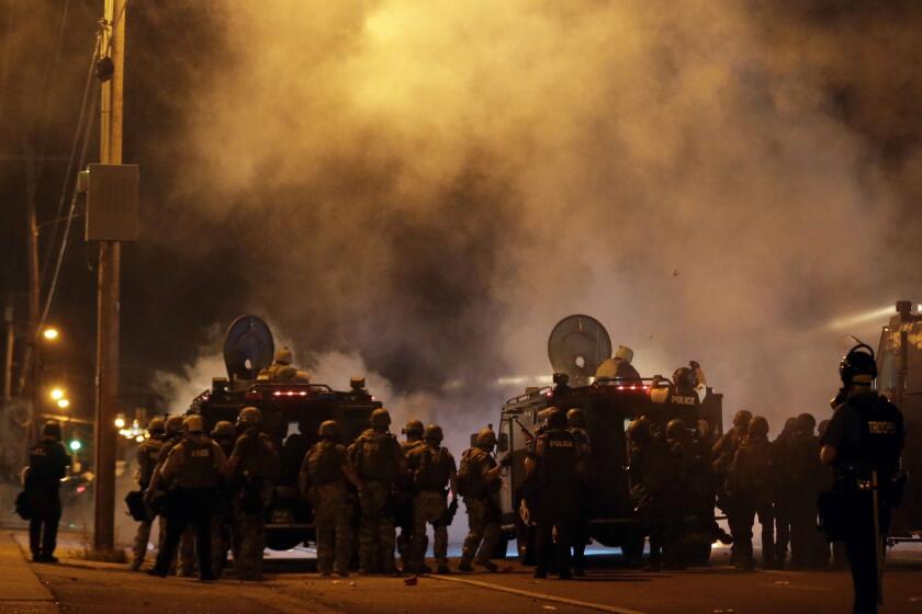 Police on the streets of Ferguson, Mo., on Sunday night.