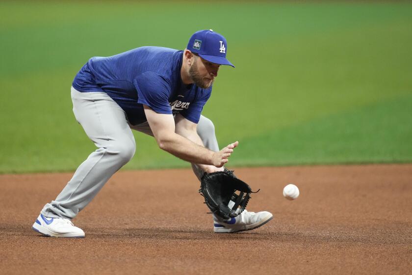 Los Angeles Dodgers third baseman Max Muncy fields a ground ball during a baseball workout at the Gocheok Sky Dome in Seoul, South Korea, Saturday, March 16, 2024. (AP Photo/Lee Jin-man)