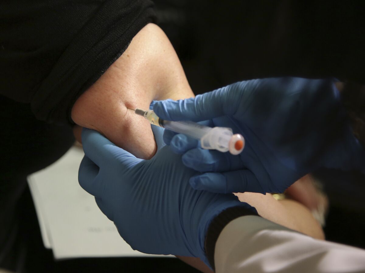 FILE - In this March 27, 2019 file photo, a woman receives a measles, mumps and rubella vaccine at the Rockland County Health Department in Pomona, N.Y., north of New York City. The number of children sickened by measles in 2019 hit the highest caseload in 23 years, according to new data published by the World Health Organization and the U.S. Centers for Disease Control and Prevention. In a study published on Thursday, Nov. 12, 2020, WHO and CDC said were nearly 870,000 cases of measles last year and that the number of deaths - about 207,500 - increased by almost 50% since 2016. (AP Photo/Seth Wenig, file)