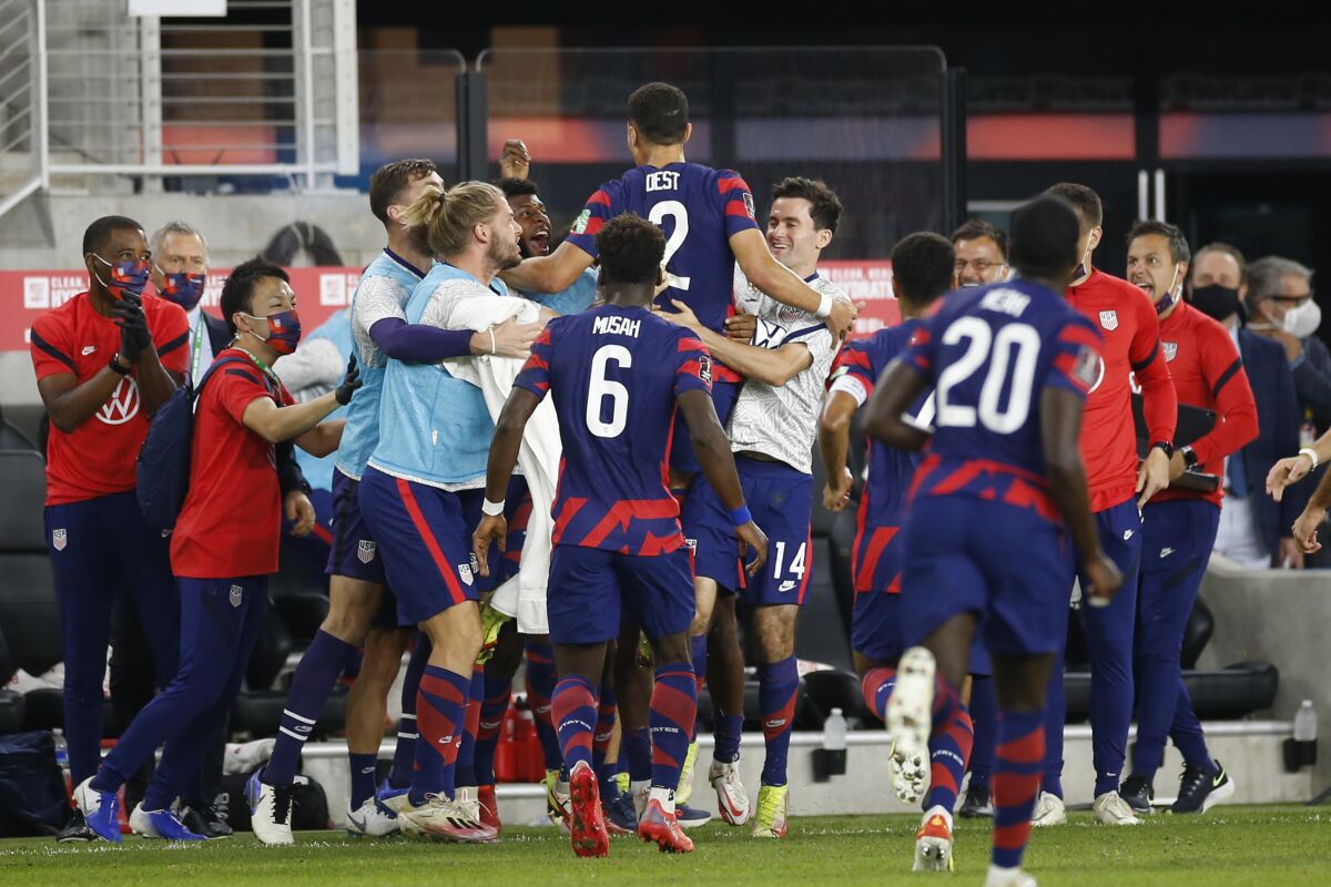 American Sergiño Dest celebrates with teammates after scoring against Costa Rica.