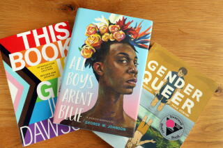 Three books are displayed on a table.