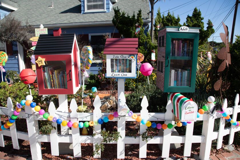 SAN DIEGO, CA - DECEMBER 02: During the pandemic Emily DoltonOs little libraries outside her Clairemont home have been busier than ever. For the holiday season the property is decorated in a Candyland theme, complete with a playable sidewalk game. Wednesday, Dec. 2, 2020 in San Diego, CA. (Jarrod Valliere / The San Diego Union-Tribune)