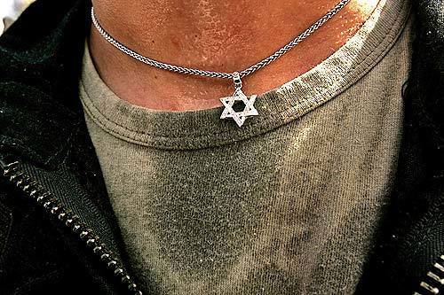 The Star of David hangs around the neck of an Israeli policeman who is part of the large force that entered Neve Dekalim.