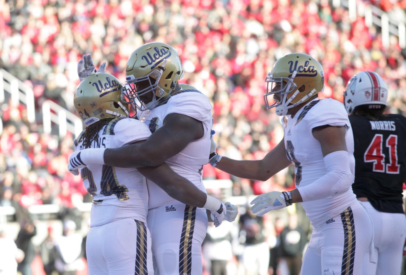 UCLA running back Paul Perkins (24) celebrates with lineman Caleb Benenoch after scoring against Utah on a two-yard run in the second half.