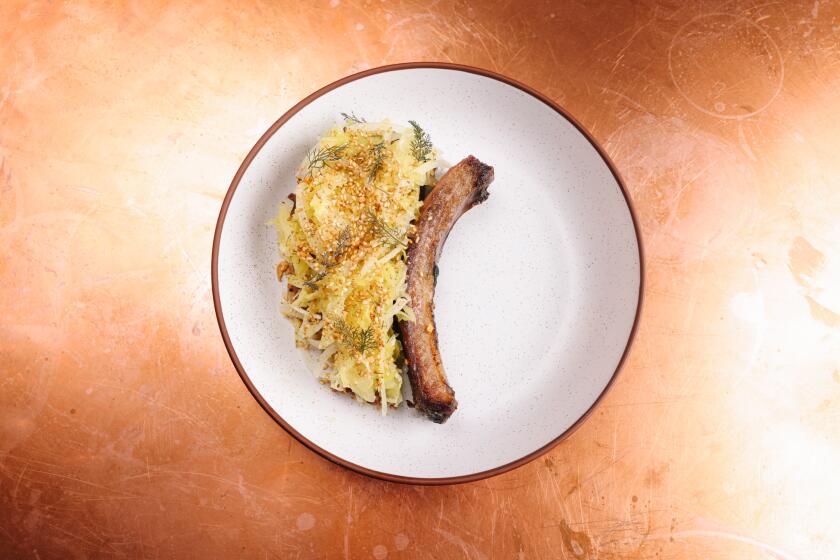 Pasadena, CA - February 14: The Ibe?rico Pork Chop dish with cabbage and fennel pollen furikake is seen at Bar Chelou on Tuesday, Feb. 14, 2023 in Pasadena, CA. (Dania Maxwell / Los Angeles Times).