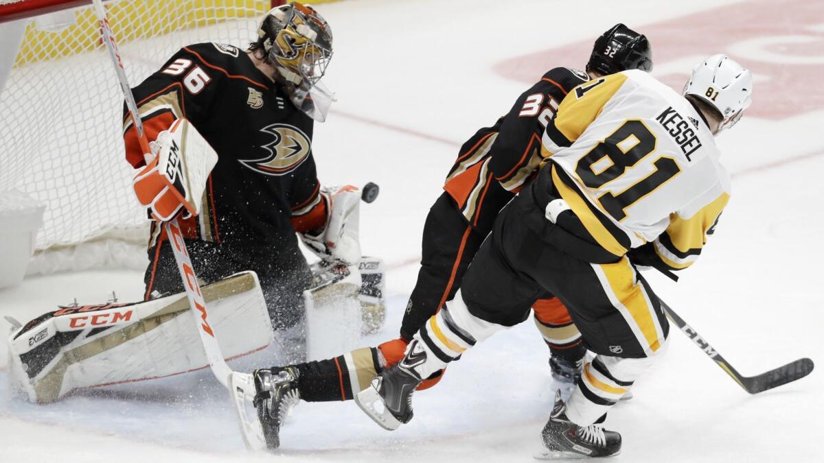 Ducks goalie John Gibson can't stop a shot that Penguins winger Phil Kessel put around defenseman Jacob Larsson during the third period Friday.
