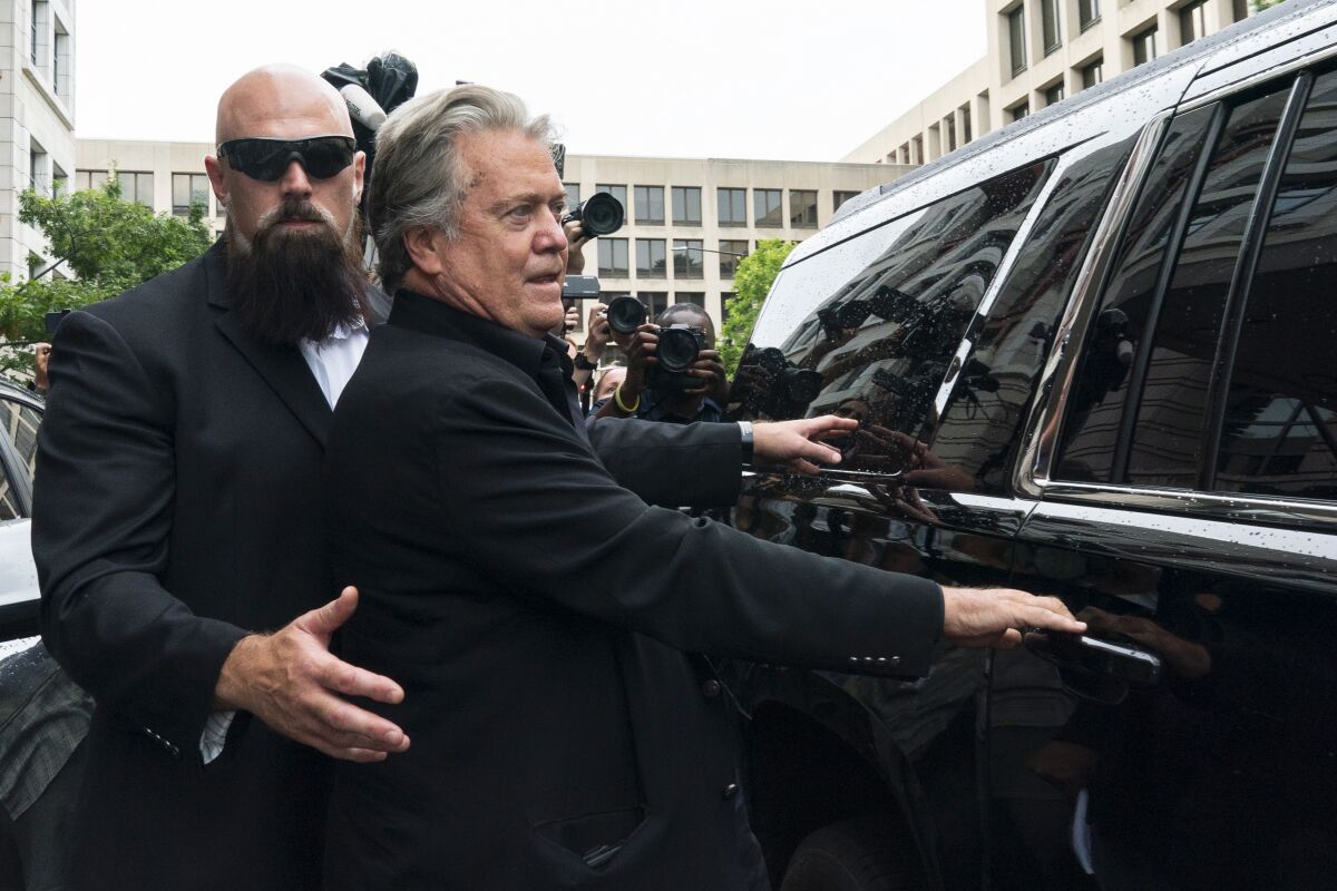 Former White House strategist Steve Bannon speaks with reporters after departing federal court in Washington. 