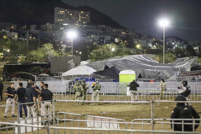 Security forces stand around a stage that collapsed due to a gust of wind during an event attended by presidential candidate Jorge Álvarez Máynez in San Pedro Garza García, on the outskirts of Monterey, Mexico, Wednesday, May 22, 2024. President Andres Manuel Lopez Obrador confirmed that multiple people were killed and at least a dozen were injured. (AP Photo/Alberto Lopez)