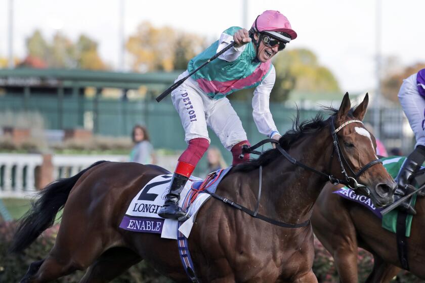 Lanfranco Dettori celebrates as he rides Enable to victory in the Breeders' Cup Turf.