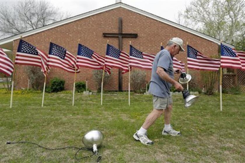 Bob Gordon works on a memorial at Central Christian Church in Killeen, Texas, for the victims the recent shooting at Ft. Hood.