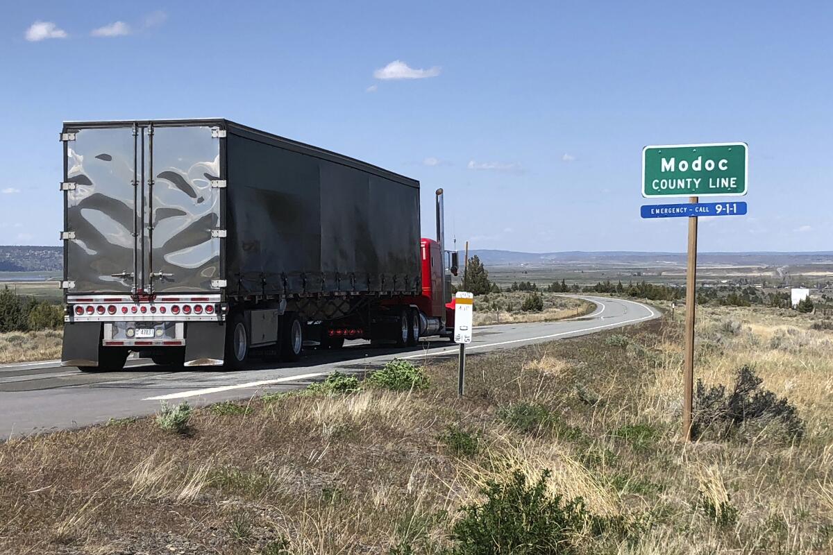 A northbound truck crosses the Modoc County line in Northern California on Friday. Modoc has seen no coronavirus cases.