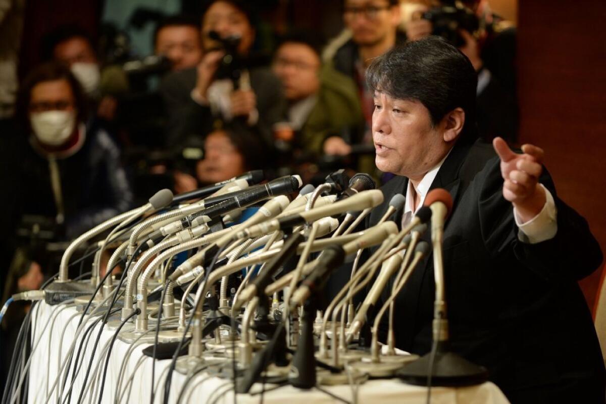 Japanese composer Mamoru Samuragochi answers questions at a news conference in Tokyo on Friday.