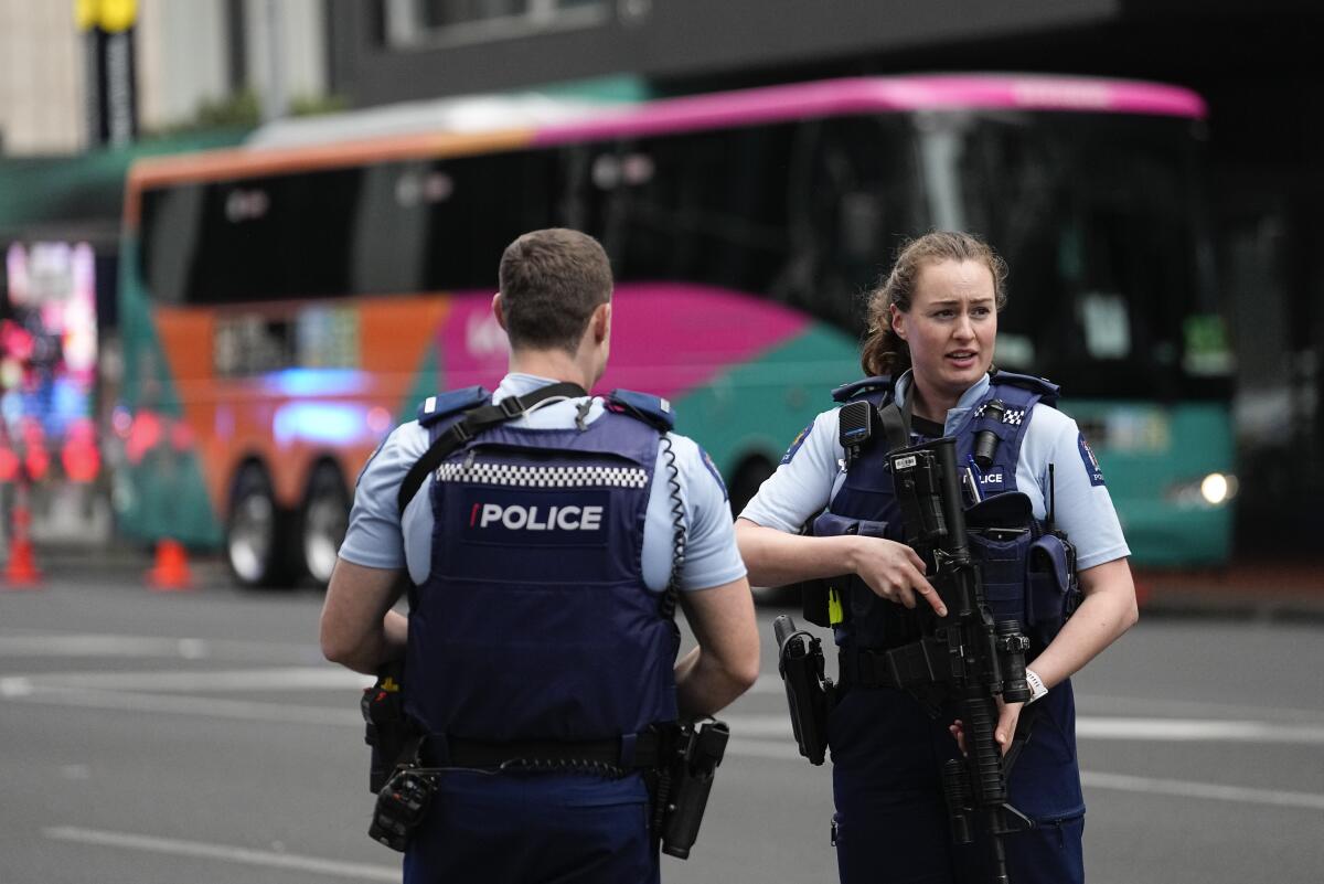 Police officers outside a hotel in Auckland, New Zealand