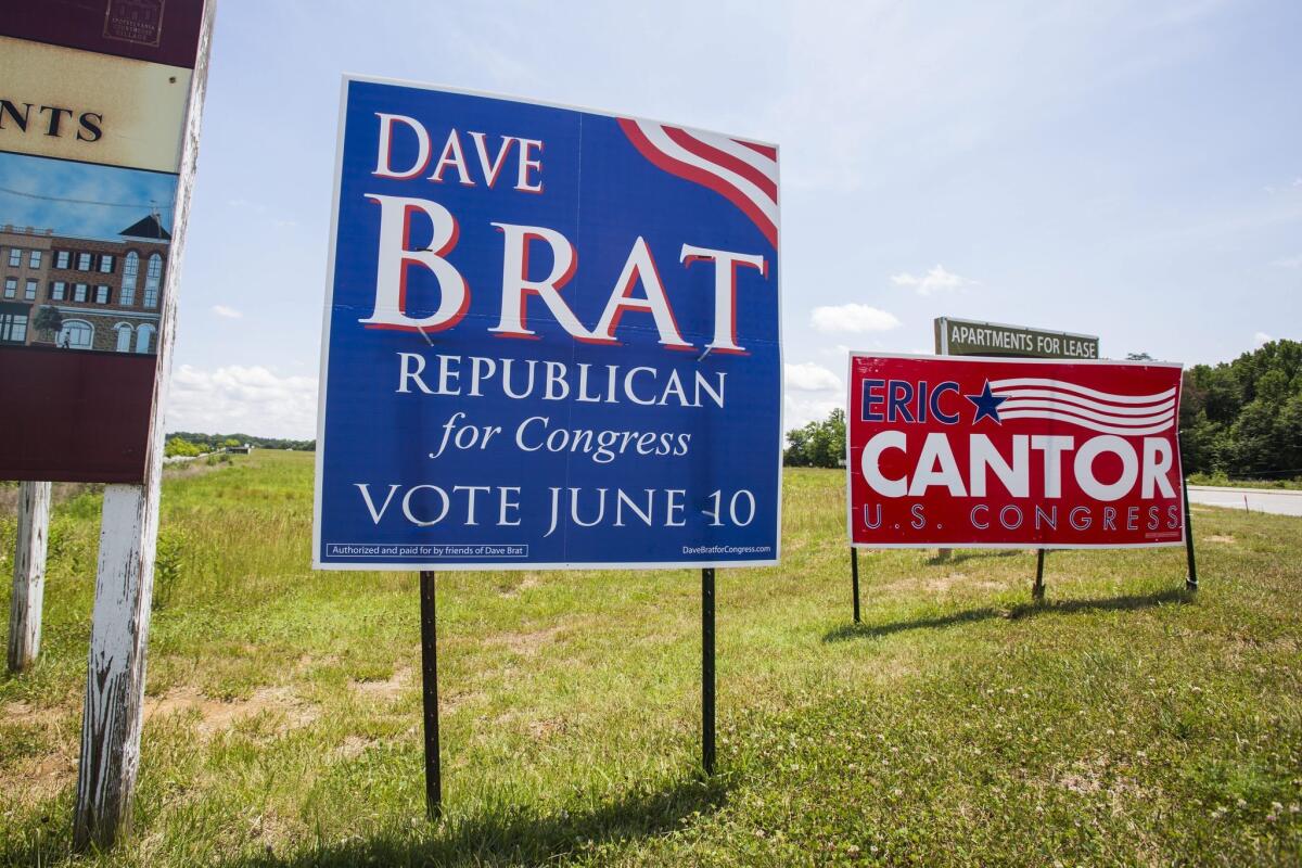Campaign signs for Republican primary candidates David Brat and Eric Cantor, an election the incumbent Cantor lost.