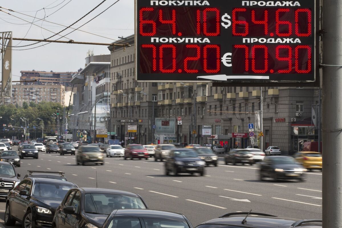 An exchange rate sign along a busy Moscow thoroughfare shows the Russian ruble had fallen Monday to 64.10 to the U.S. dollar -- a decline of at least 43% over the last year as slumping oil prices and sanctions hit the Russian economy.