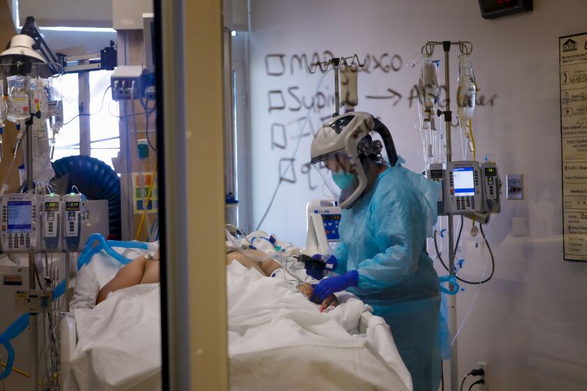 Wearing a PAPR PPE, Kristen Wilson, RN checks on a COVID-19 patient at El Centro Regional Medical Center on June 10th, 2020.