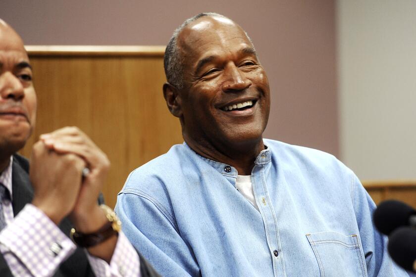 FILE - In this July 20, 2017, file photo, former NFL football star O.J. Simpson reacts after learning he was granted parole at Lovelock Correctional Center in Lovelock, Nev. Simpson got into a series of minor legal scrapes following his 1995 acquittal of murder charges in the deaths of his wife Nicole Brown Simpson and her friend Ronald Goldman. (Jason Bean/The Reno Gazette-Journal via AP, Pool, File)