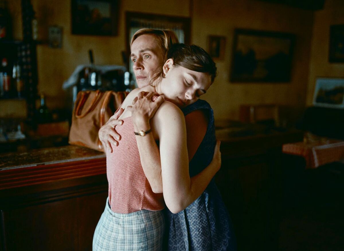 Two women embrace