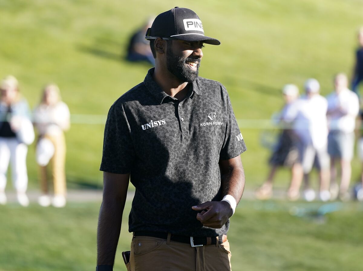 Sahith Theegala smiles after finishing his first nine holes during the Phoenix Open golf tournament Thursday, Feb. 10, 2022, in Scottsdale, Ariz. (AP Photo/Darryl Webb)