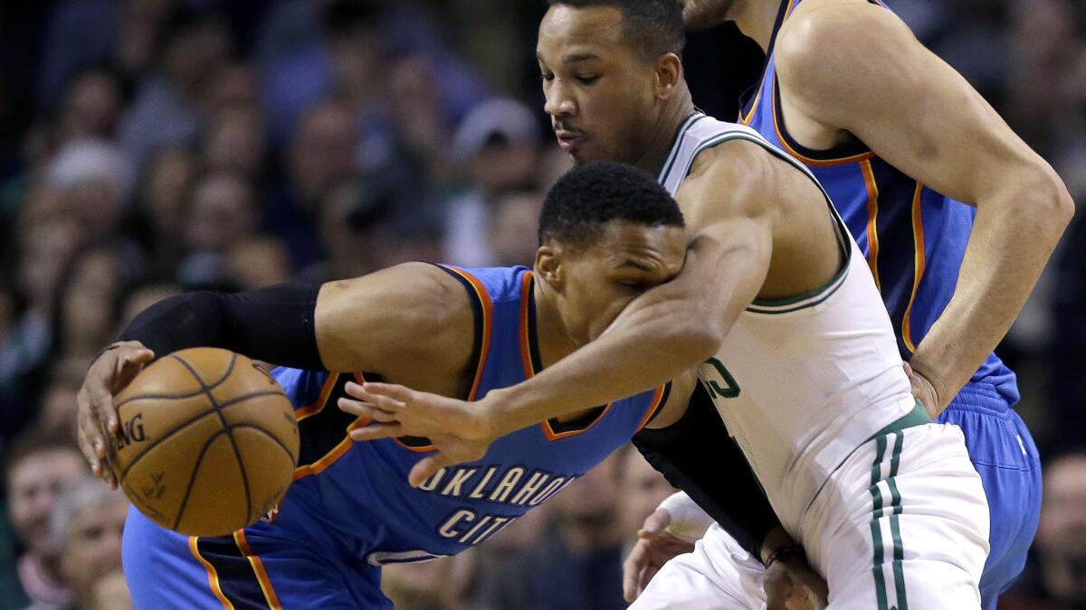 Thunder guard Russell Westbrook, left, meets some resistance from Celtics guard Avery Bradley during a drive in the first half Friday night.