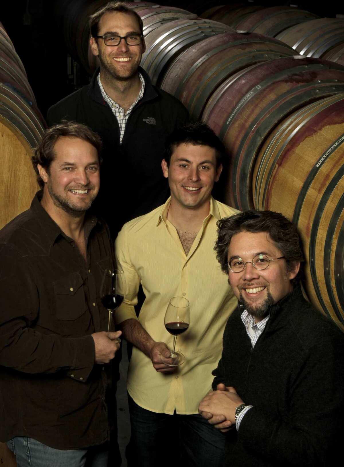 From left, Chad Melville of Melville & Samsara, Justin Willett of Tyler Winery, Ryan Zotovich of Zotovich Cellars, and Sashi Moorman of Evening Land Vineyards, in the Evening Land Vineyards cellar.