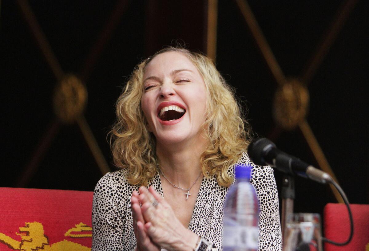 Madonna took to Instagram on Wednesday to deny reports that her new album had been leaked online in its finished form. Above, the artist during a visit last month to Malawi.