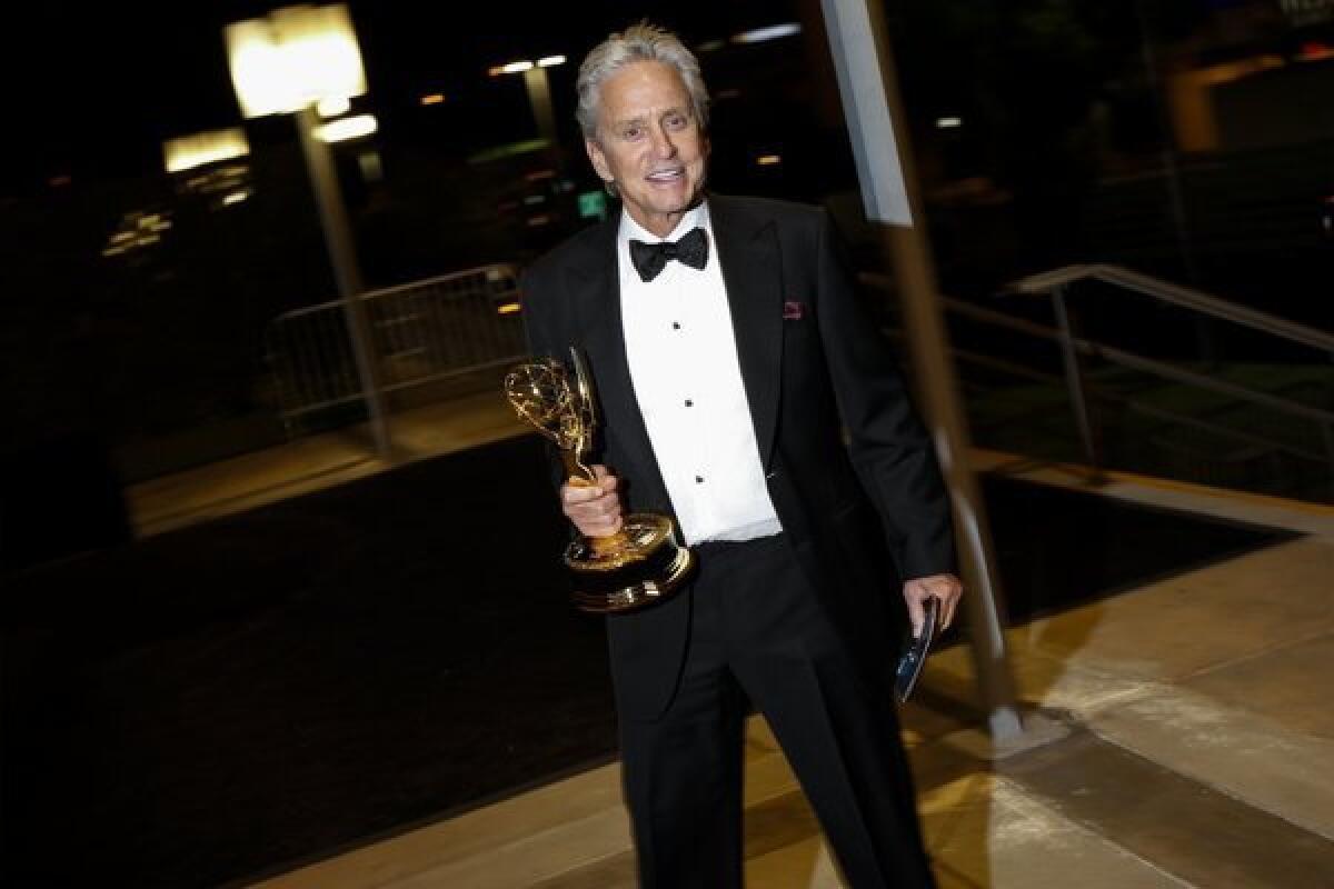 Michael Douglas, Emmy winner for lead actor in a miniseries or movie for "Behind the Candelabra," makes his way to the Governor's Ball, following the Emmy Awards at Nokia Theatre.
