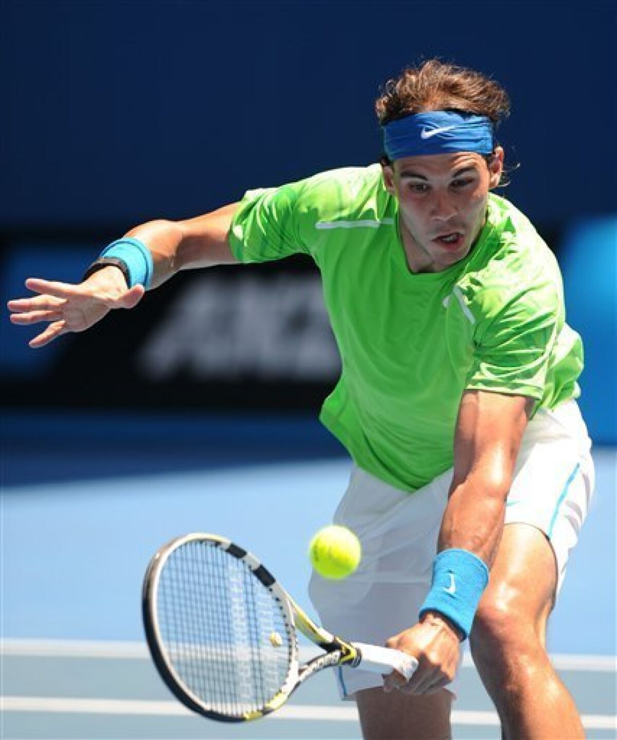 Spain's Rafael Nadal makes a backhand return to Germany's Tommy Haas during their second round match at the Australian Open tennis championship, in Melbourne, Australia, Wednesday, Jan. 18, 2012. (AP Photo/Andrew Brownbill)