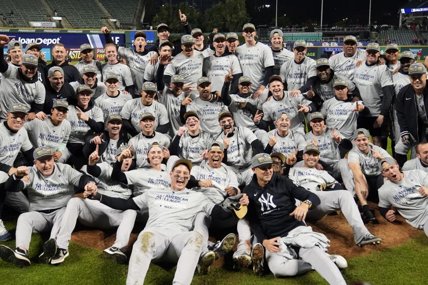 New York Yankees players pose for a team picture after Game 5 of the baseball AL Championship Series.