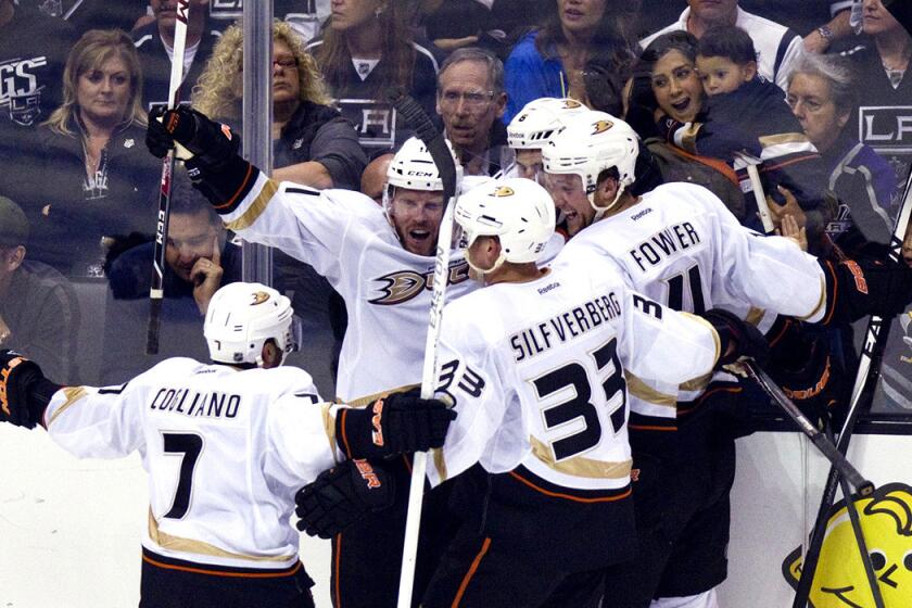 Kings fans try not to watch the Ducks players celebrate after a goal by Ben Lovejoy in the third period gave Anaheim a 3-1 lead.