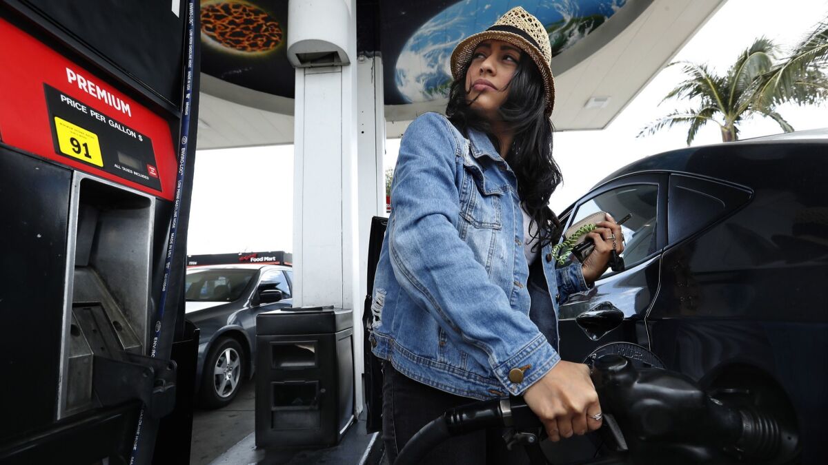 Jessica Martinez of Sherman Oaks fills up. The state gas tax goes up 5.6-cents per gallon on July 1.