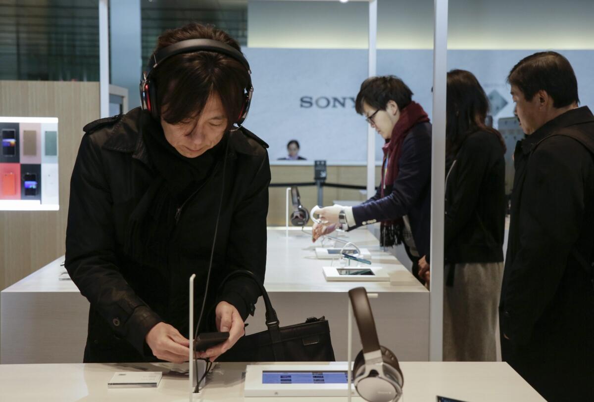Visitors check products at the showroom of Sony Corp. headquarters in Tokyo.