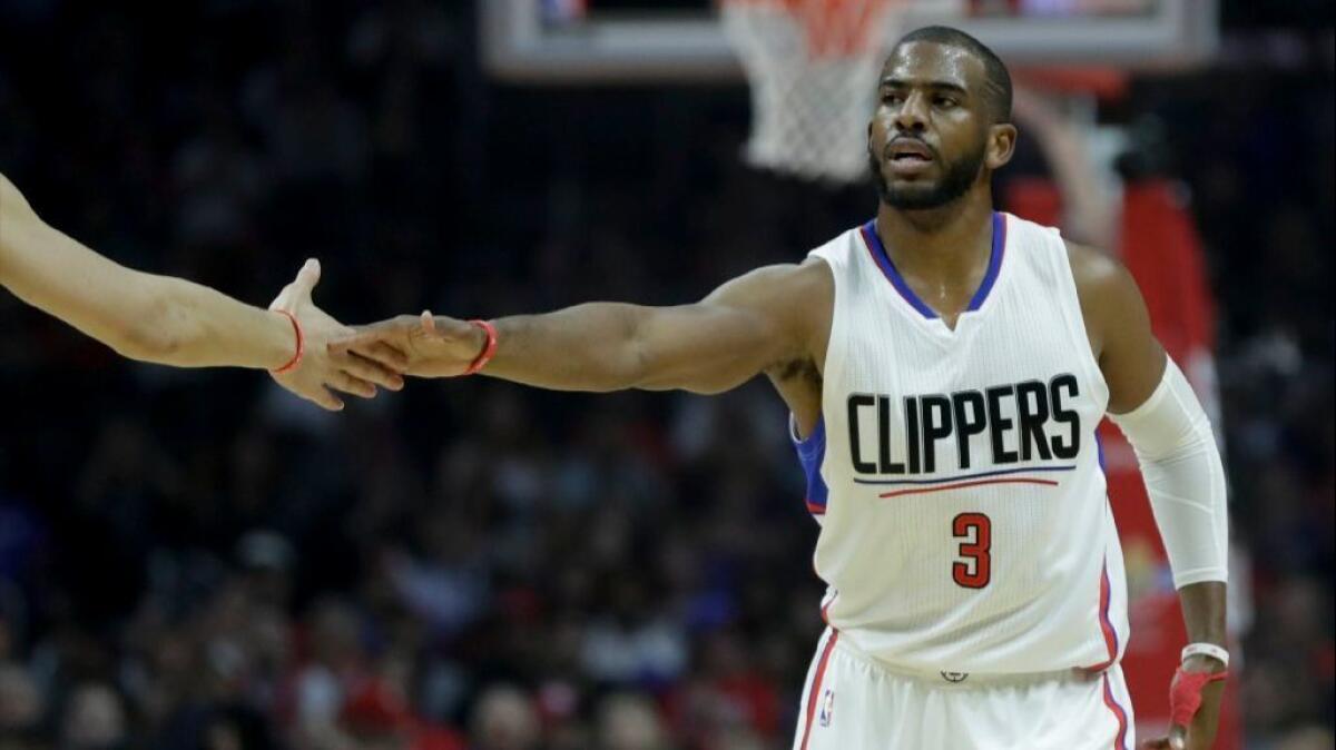 Clippers guard Chris Paul celebrates after scoring during the first half against the 76ers.