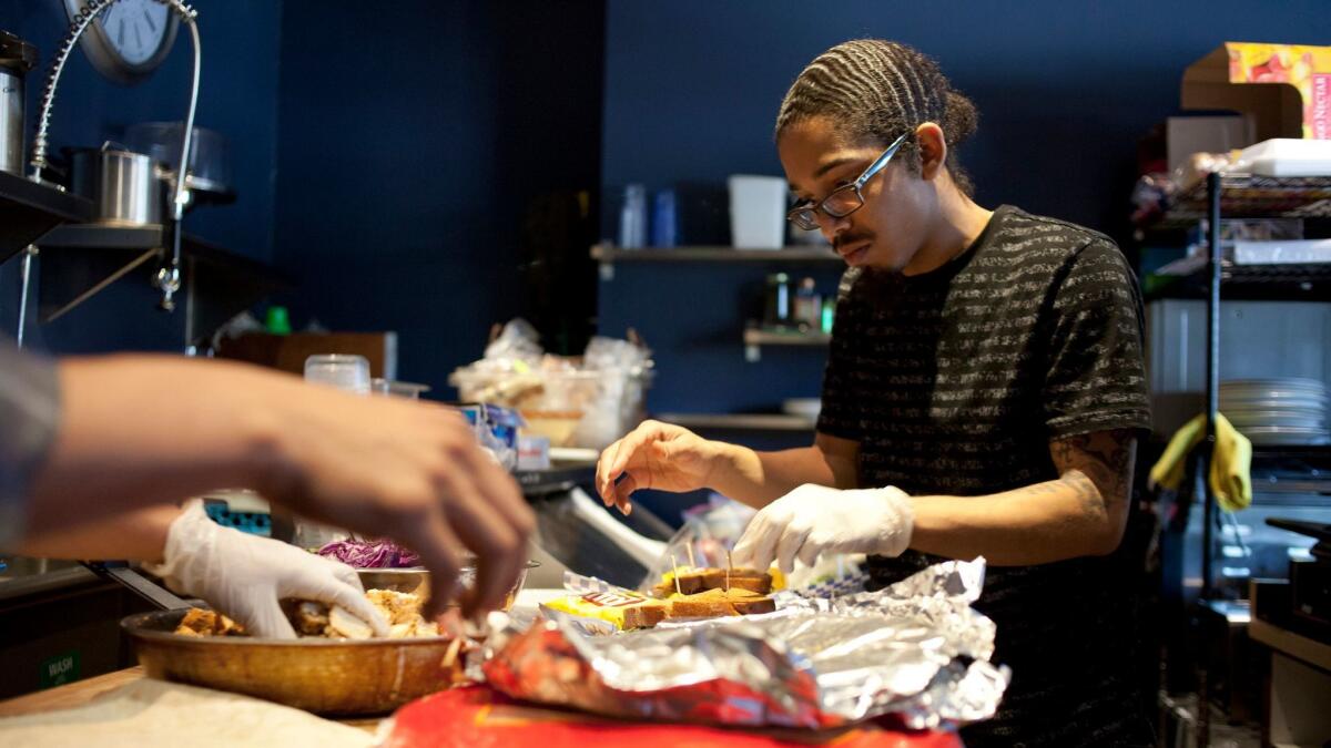 Employee Keenan Leal, 23, prepares food at the Manifesto Cafe in Los Angeles on April 9, 2015.