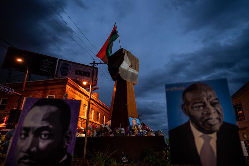 MINNEAPOLIS, MN - MAY 24: The Fist Sculpture at the intersection of 38th Street and Chicago Avenue stands as a memorial for Floyd at George Floyd Memorial Square on Monday, May 24, 2021 in Minneapolis, MN. (Kent Nishimura / Los Angeles Times)